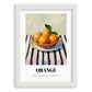 Orange – on Striped Tablecloth, Fruit Still Life, placed in minimal white frame
